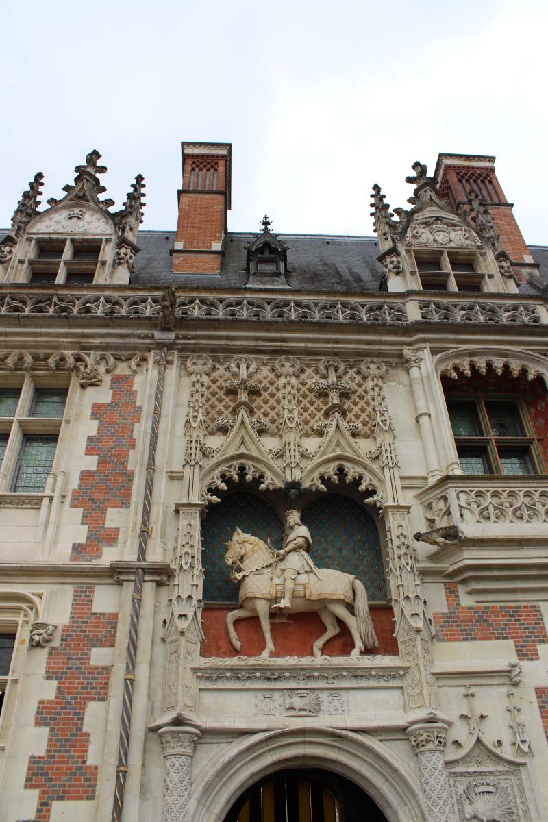 Main entrance to the Royal Château. The gate is part of the Louis XII wing. Louis XII himself is shown in the statue of the mounted king above the entrance