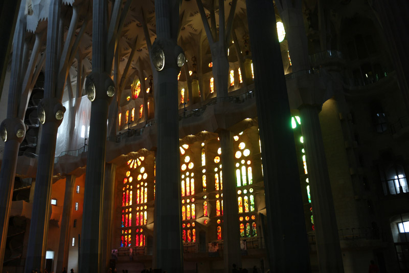 Side nave illuminated through the colorful windows of the basilica