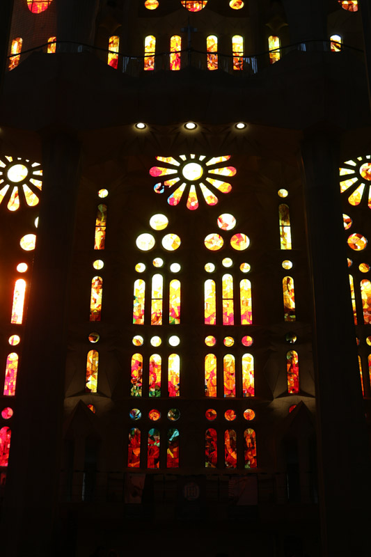 Side nave illuminated through the colorful windows of the basilica