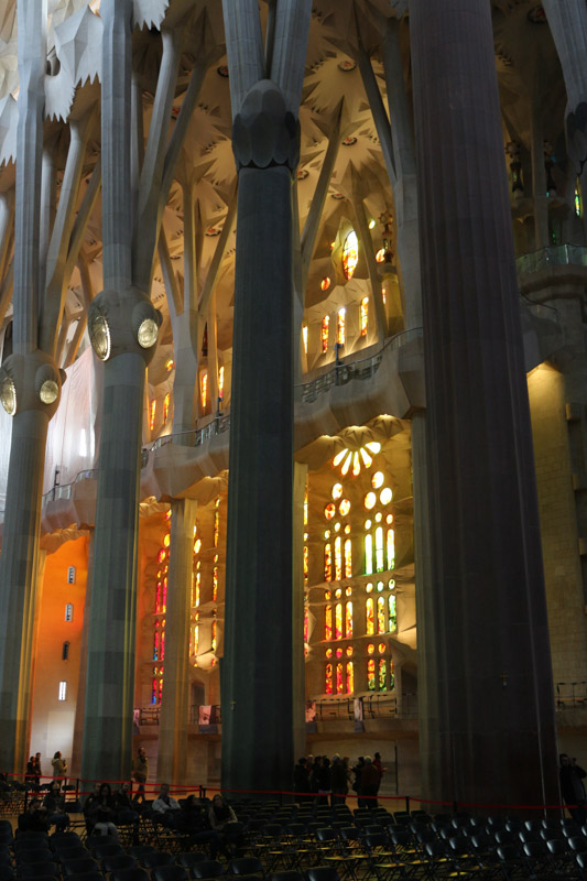 Side nave illuminated through the colorful windows of the basilica