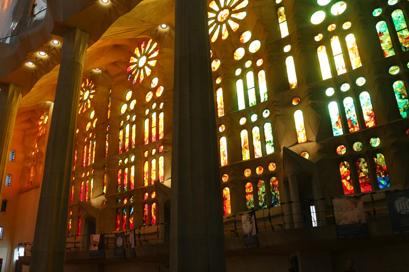 Light coming through& the colorful windows of the basilica