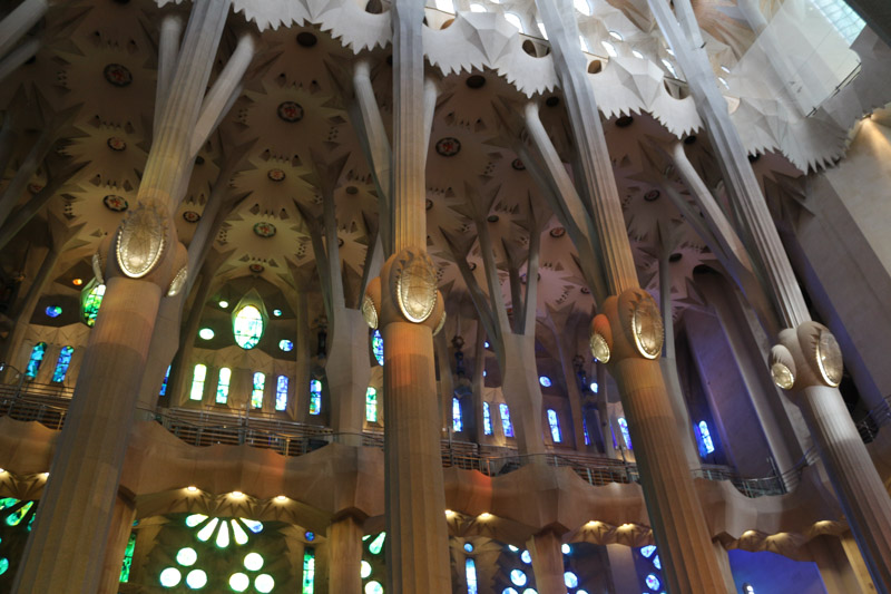 Side nave illuminated through the colorful windows of the basilica