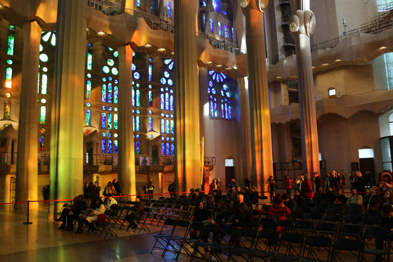 Light coming through& the colorful windows of the basilica