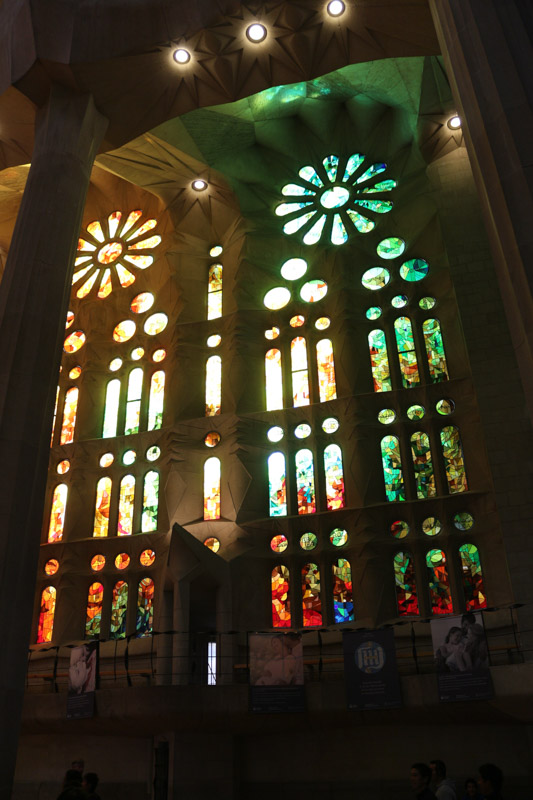 Side nave illuminated through the colorful windows of the basilica