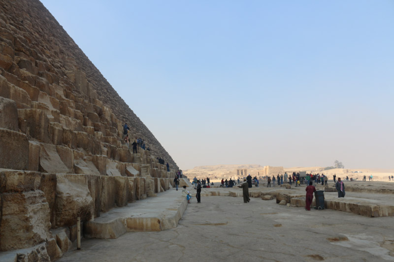 It is thought that, at construction, the Great Pyramid was originally 280 Egyptian cubits tall (146.5 metres (480.6 ft)), but with erosion and absence of its pyramidion, its present height is 138.8 metres (455.4 ft). Each base side was 440 cubits, 230.4 metres (755.9 ft) long. The mass of the pyramid is estimated at 5.9 million tonnes.