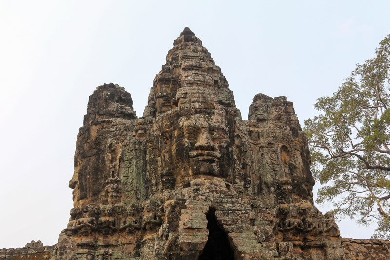 Northern Angkor Thom gate with big stone faces watching over the entrance