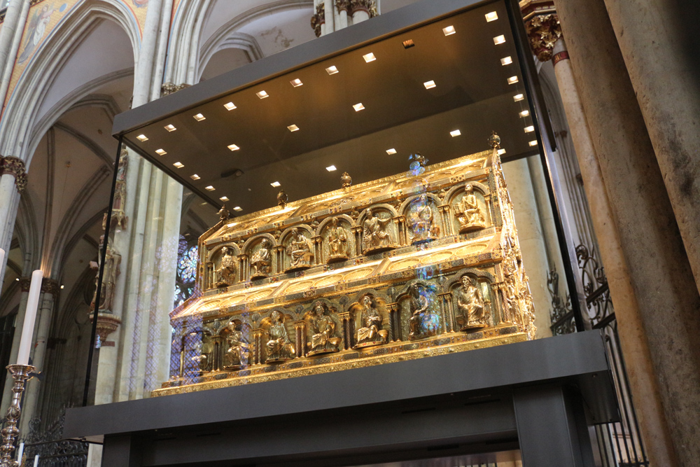The Shrine of the Three Kings from the 13th century dominates the center of the Cologne Cathedral choir. It is traditionally believed to hold the remains of the Three Wise Men, whose relics were acquired by Frederick Barbarossa at the conquest of Milan in 1164. It is said to be the largest medieval gold work in Europe (it is however mostly made of silver and only has an outer golden layer).