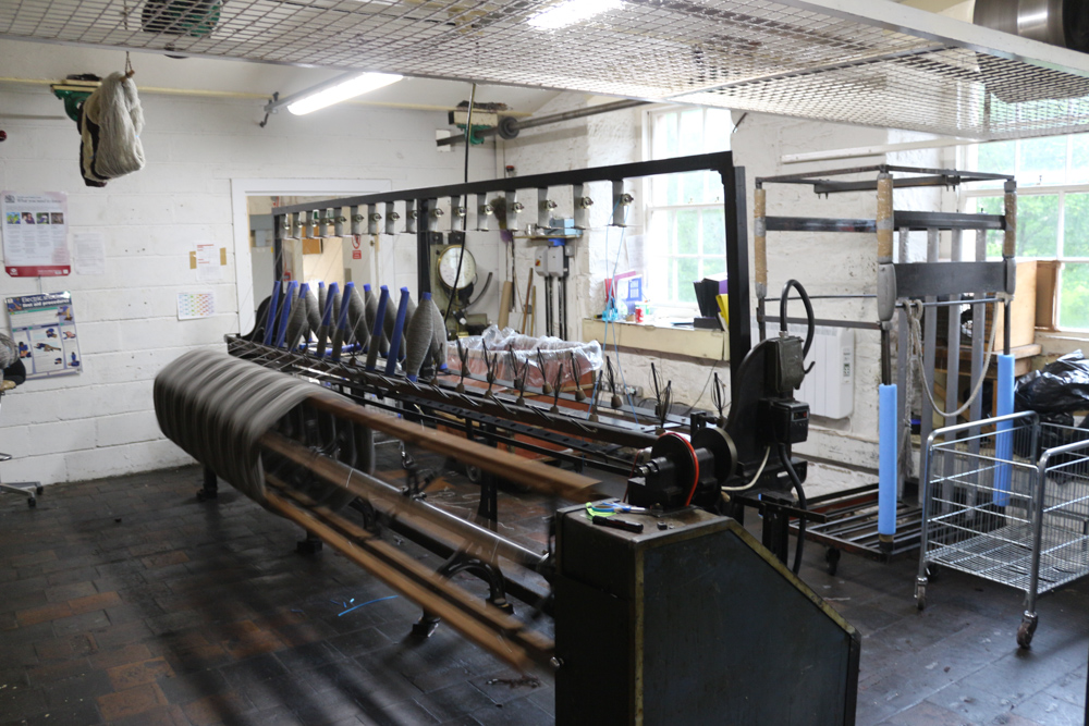 Originale, funktionierende Maschinen werden auf dieser Etage des New Lanark Museums gezeigt. Auf den alten Maschinen der Baumwollfabrik wird heute wieder etwas Kleidung produziert.