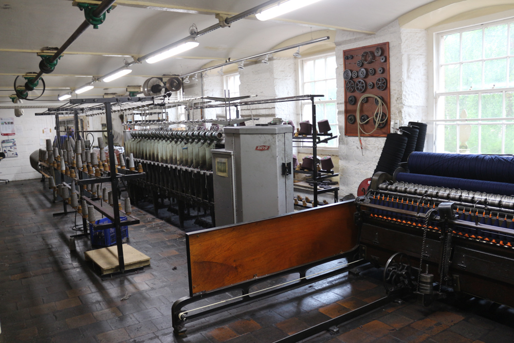 Original, working mill machinery is shown on this floor of the New Lanark museum