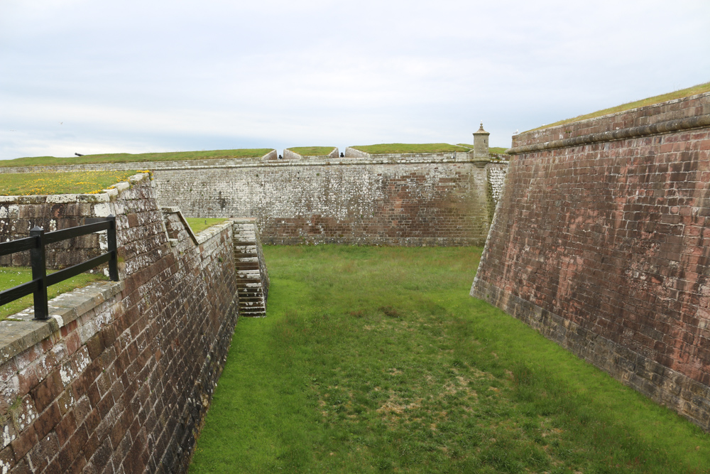 The dry moat separates the outer earthworks from the fort