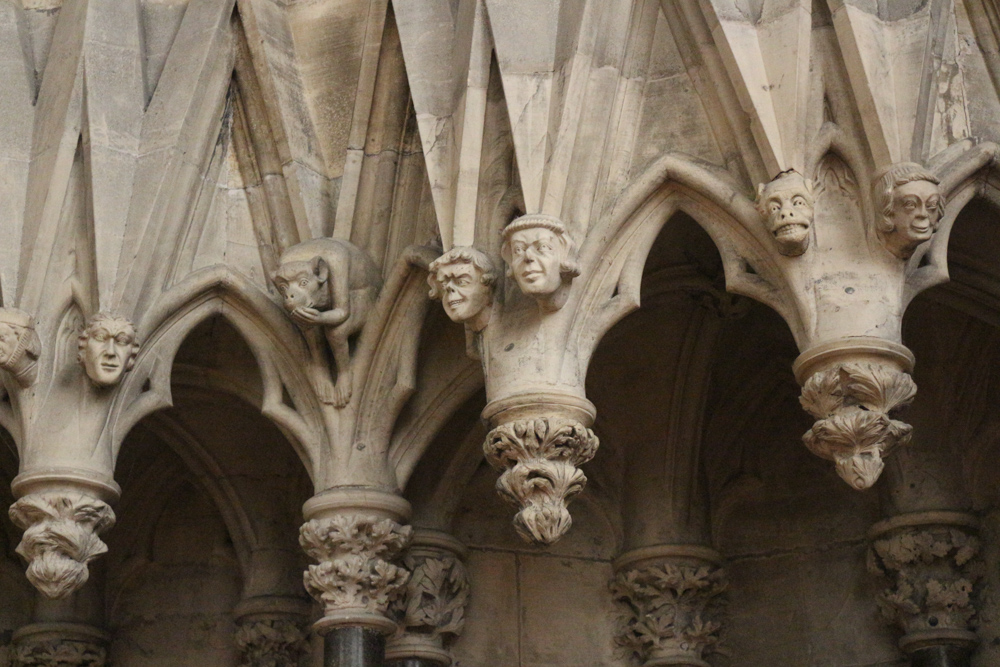 The gothic chapter house of York Minster in decorated with hundreds of small stone heads showing all kinds of facial expressions