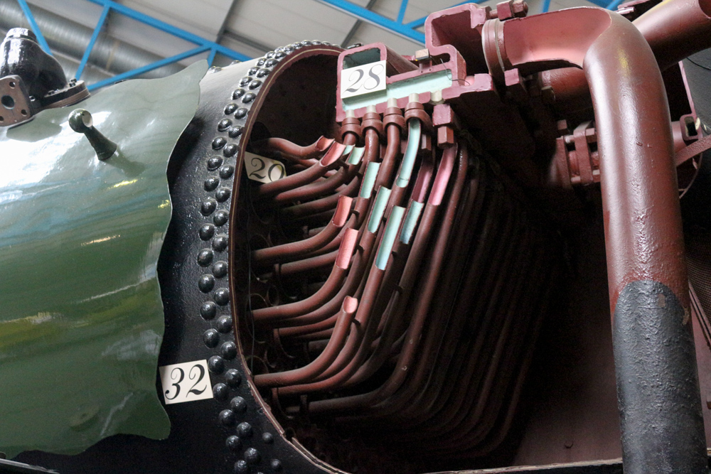 National Railway Museum (NRM): Ellerman Lines (1949) sectioned steam locomotive no. 35029. (20) is the front tube-plate. (29) are superheater elements to increase steam temperature. (32) are rivets showing where the front tube-plate is fitted into the boiler.