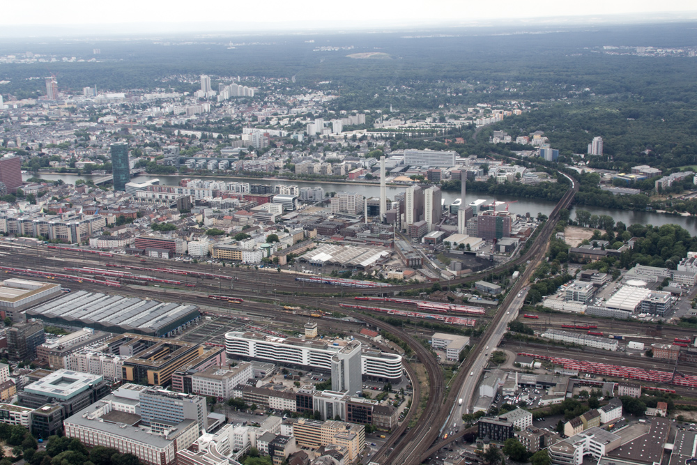 View from a helicopter over Frankfurt: Track field of Frankfurt main train station plus the Heizkraftwerk West power plant. The river Main is cutting the city in half.
