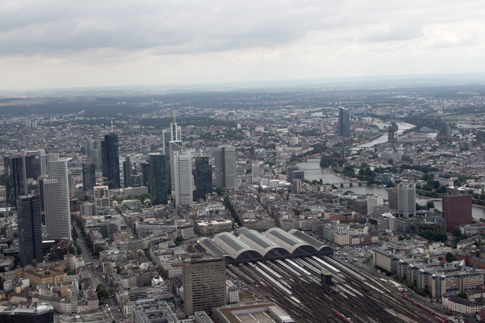 View from a helicopter over Frankfurt: Downtown Frankfurt skyline and main train station. In the background the European Central Bank on the right side.