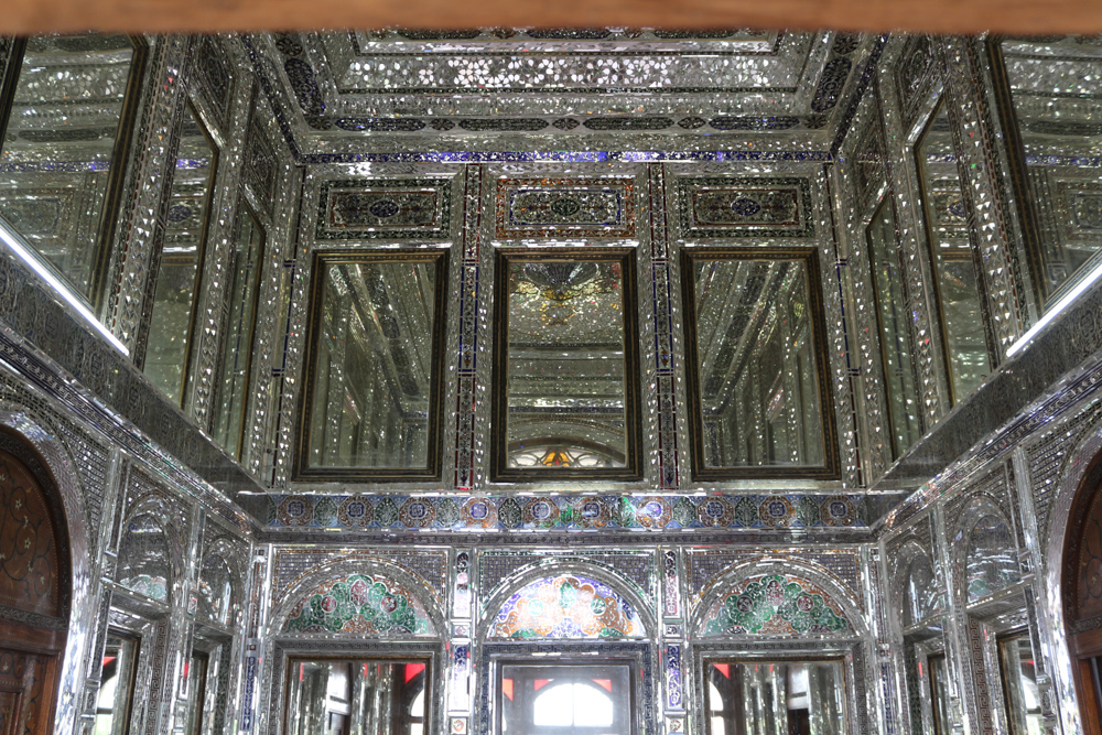 The walls and ceiling of the small pavilion inside Ghavam Garden is covered with small mirrors