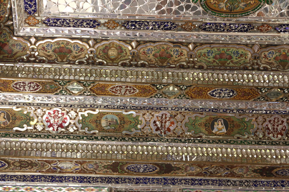 The walls and ceiling of the small pavilion inside Ghavam Garden is covered with small mirrors