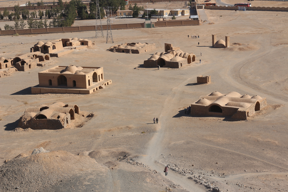 Panorama of the buildings around one of the Silent Towers of Yazd. The walled area is the new Zoroastrian cemetery. The dead are now buried in concrete boxes so that they do not touch the soil.