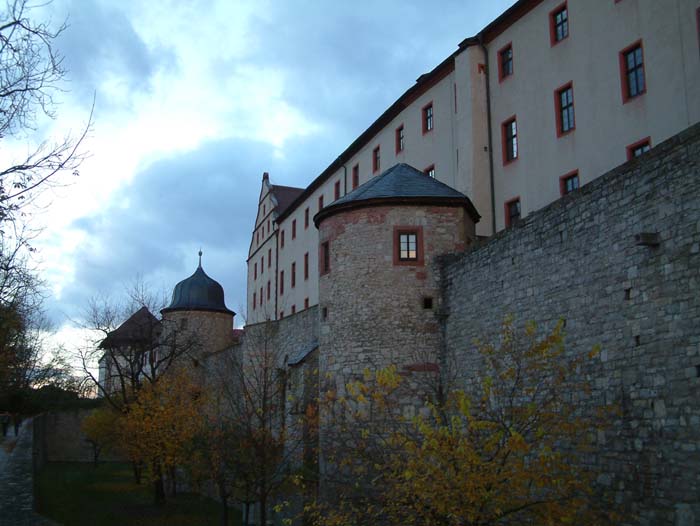 The Fortress Marienberg is the castle on a hill across the Old Main Bridge, overlooking the whole town area as well as the surrounding hills