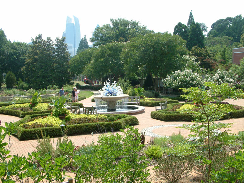 Parterre Garden before the Exhibit Hall with a glass scuplture by Dale Chihuly in the Atlanta Botanical Garden