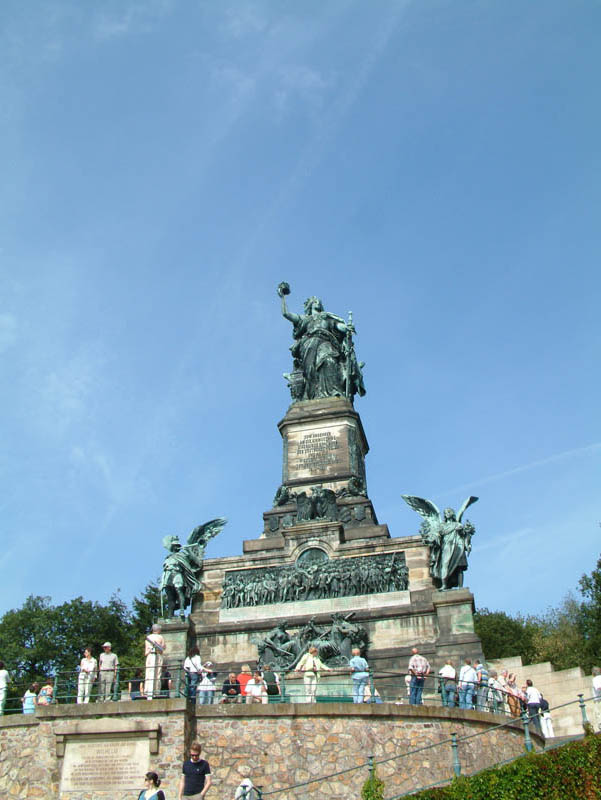 The foundation of the Niederwalddenkmal was laid on September 16, 1877 by the German emperor Wilhelm I. The 38 meter high monument with the 10.5 meter statue of "Germania" symbolize the "Wacht am Rhein" (poem by Max Schneckenburger which might be translated with "Watch on the Rhine") and remember the restoration of the German Empire directly after the Franco-Prussian War.