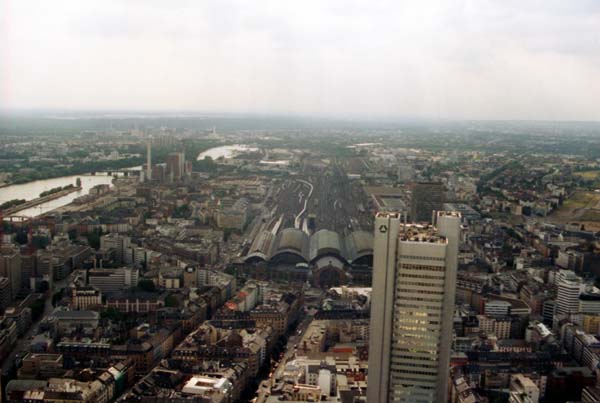 View from the top of the Commerzbank Tower: The silver headquarters of Dresdner Bank and the main train station with its extensive train tracks.