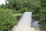 Small wooden bridge crossing the lake of Stourhead Gardens