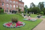 Hughenden Manor is a red brick Victorian mansion. View from the park behind the house.