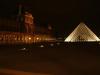 By night the Musée du Louvre is illuminated by thousands of small lights hidden in niches and protrusions of the baroque facade the magnificent museum.