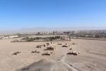 Panorama of the buildings around one of the Silent Towers of Yazd. The walled area is the new Zoroastrian cemetery. The dead are now buried in concrete boxes so that they do not touch the soil.